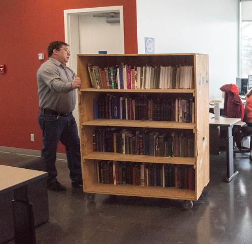 Blair Cherniawsky, facilities manager for Libraries and Cultural Resources, wheels in part of the first shipment of 3,200 books. 