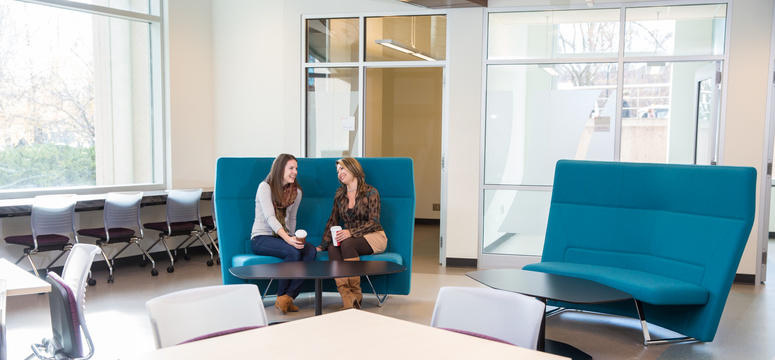 Janessa Burke, a nursing student, and Leda Stawnychko, manager of administration in the Faculty of Nursing, visit in the new student space on the bottom floor of the Professional Faculties Building