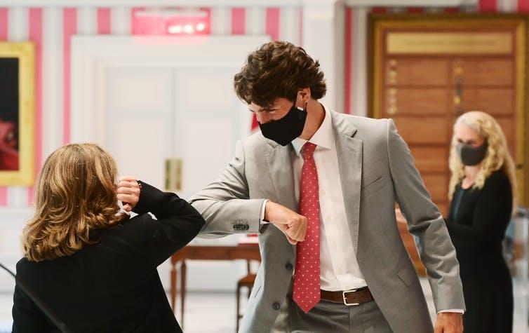 Chrystia Freeland elbow bumps Prime Minister Justin Trudeau after being sworn in as Finance Minister on Aug. 18, 2020.