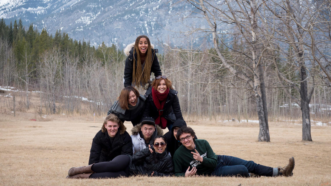 Students create a pyramid of people