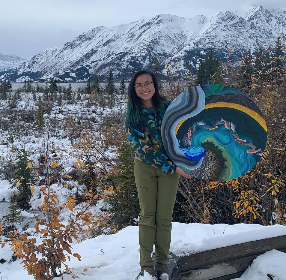 Megan Leung holds up her painting, Kluane’s Symphony