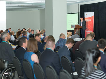 David Yiptong, Director of Programs for Platform Calgary emceeing for the 2019 TENET i2c competition finals at INVENTURE$ 2019 on June 7th, 2019.