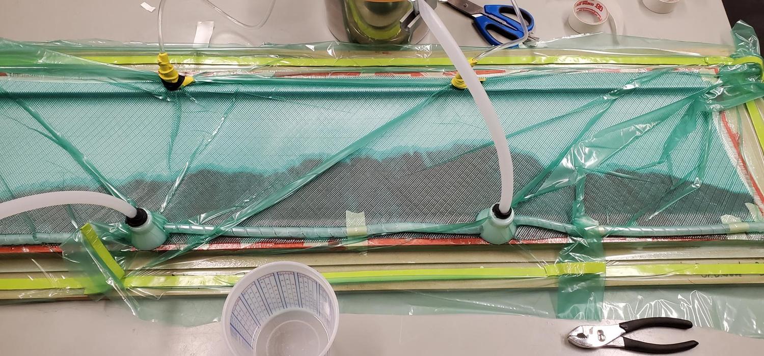 Half a small wind turbine blade being made by infusing resin through a glass fibre layup in a mould made at UCalgary.  This work was done by Dr. Wood’s summer student, Deep Patel to provide the background knowledge – and maybe blade moulds – to support the Uganda project.