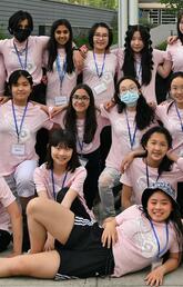 A group of people in matching pink shirts