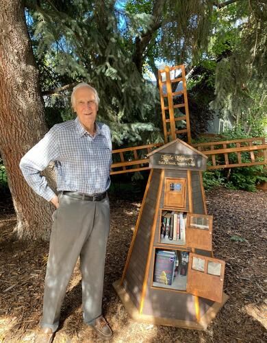 Man standing next to windmill structure