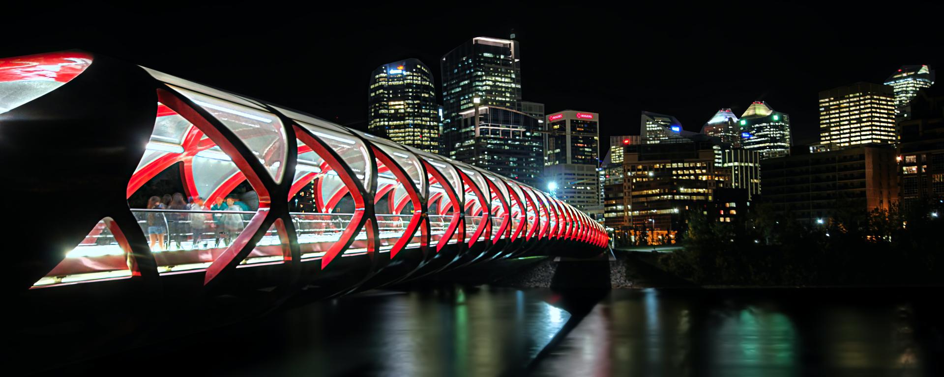 A night shot of the Peace Bridge over the Bow River in Calgary