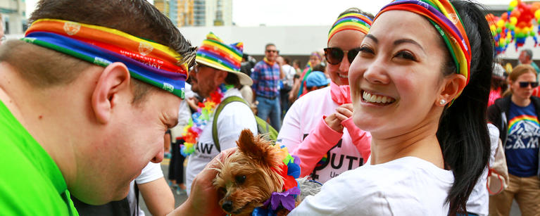 Students are having fun at the event and one of them is petting a cute dog