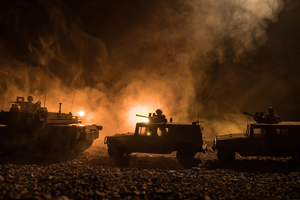 Three tanks backlit in the dark