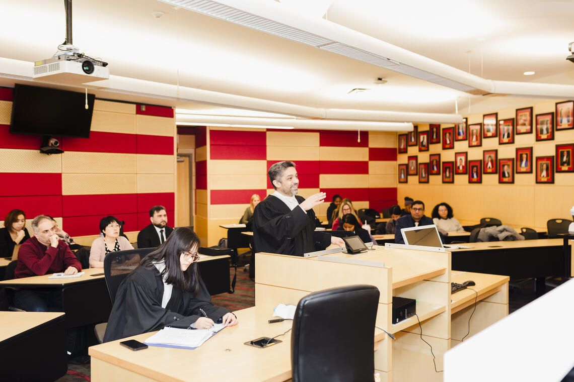 Student standing at podium smiling
