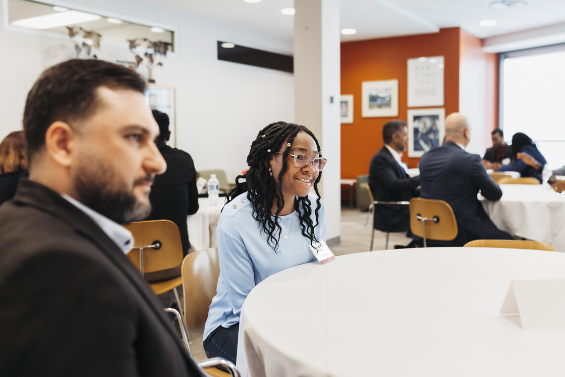 Students gathered around table smiling