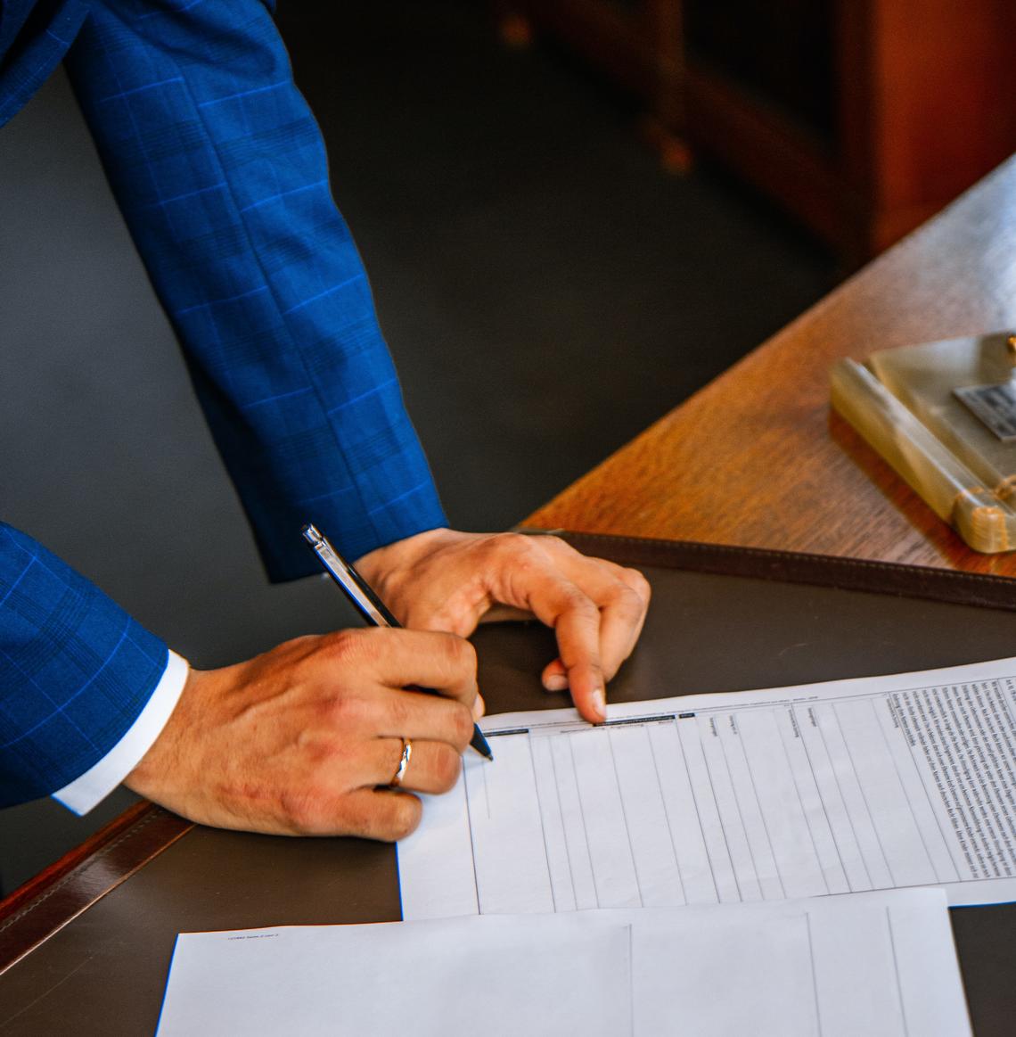 Man in suit signing a contract
