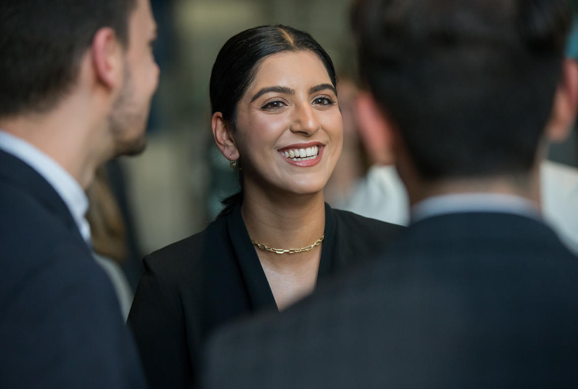 A student smiles in a crowd