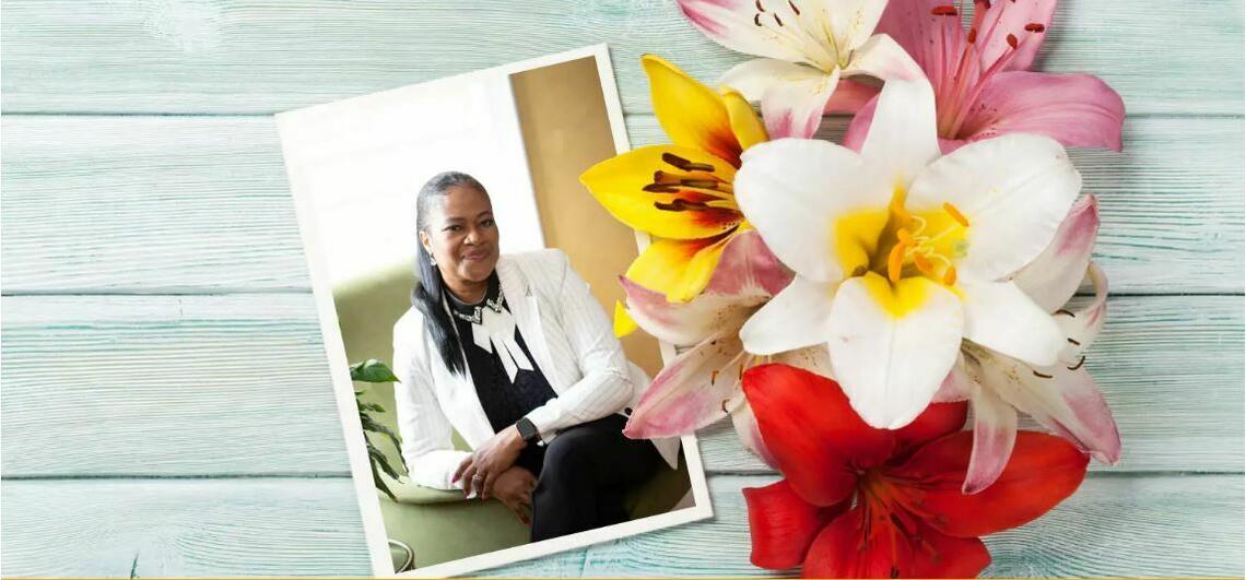 Photograph of Althea Francis next to flowers on a table