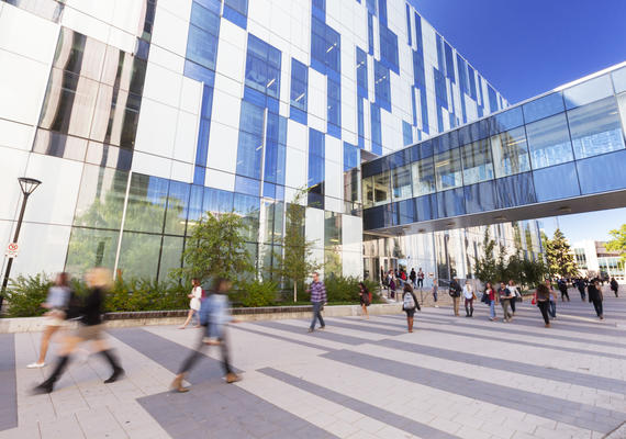 Students walk on campus on a beautiful day