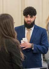 A student engages in conversation during a networking event