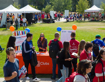 Students gathered around club booths outside