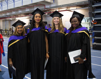 Four law graduates posing for a photo at convocation